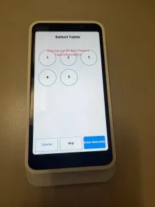 The "Select Table" screen with numbered buttons for tables 1-5 and an "Enter Manually" option.